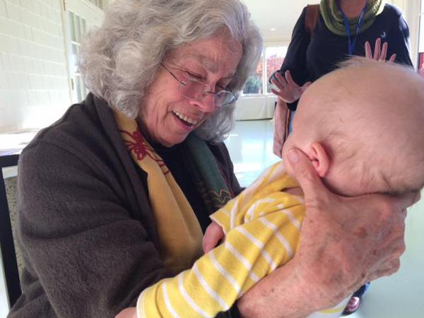 Ann Jennings, a pioneer in trauma-informed practices runs the SPSCOT list serv. She's talking with Louie, Leslie Forstadt's two-month old son. 