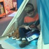 A student using a station in our wellness center: This station is called “Native Beach” and is equipped with a tee-pee, a turtle with blue lights and the sound of the ocean, and ocean-themed creatures, books and seashells