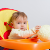Baby with ball in highchair 1 .png  - BrainInsightsonline.com