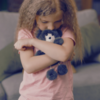 Sad girl with teddy bear -
